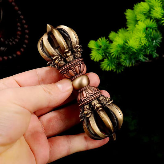 Handcrafted brass nine-pronged vajra handle from Tibetan Buddhist ritual implements culture, symbolic of spiritual power and protection in Buddhist ritual implements art.