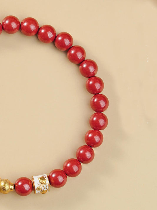 Artisan-crafted red cinnabar bead bracelet inspired by Tibetan Buddhist jewelry culture, highlighting detailed craftsmanship and jewelry art style.