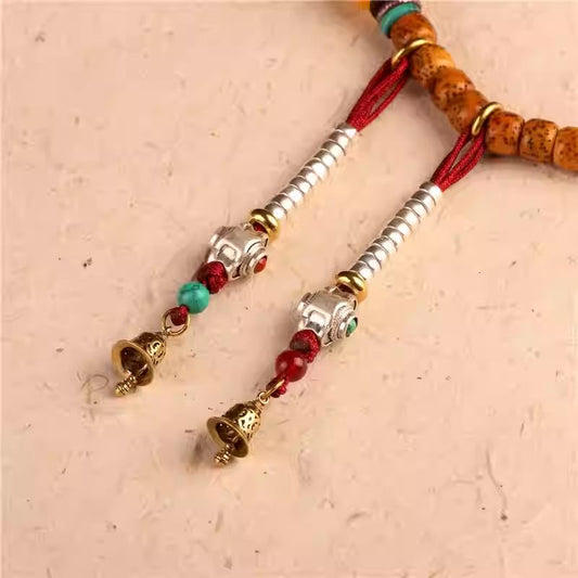 Vintage Tibetan style brass and white copper auspicious cloud bell charm, exquisite handmade jewelry art accessory.