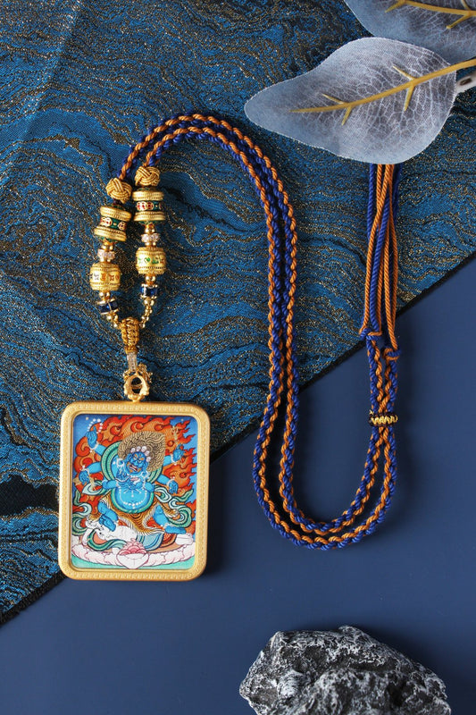 A 4x5cm hand-painted Six-Armed Mahakala Thangka pendant from Rebgong, featuring a blue cloud background and vintage copper frame.
