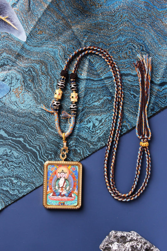 A 3.5x4.5cm hand-painted Rebgong Vairocana Thangka pendant, depicting the supreme Buddha of light in mineral pigments and a titanium steel frame.