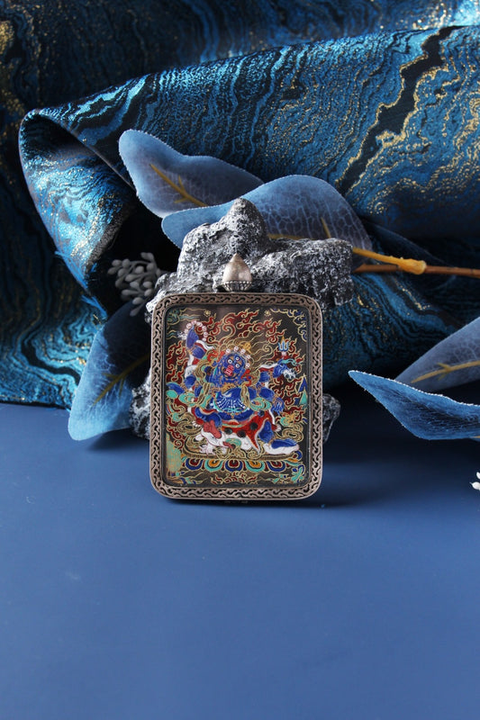 Detailed view of the ultra-fine pure gold powder painting on the black background of the Mahakala Thangka pendant.