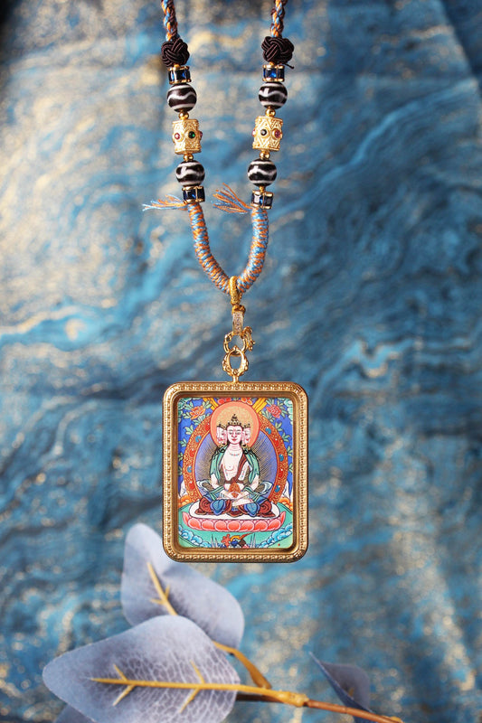 A hand-painted Rebgong Akasagarbha Thangka pendant, the Buddha of infinite wealth, showing vibrant mineral colors.