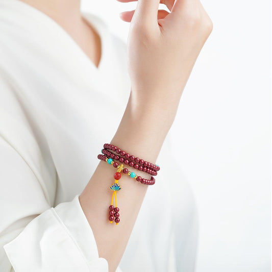 Tibetan-style cinnabar 108 mala crafted with amber and glass accents, artisanal Buddhist prayer beads.