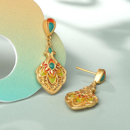 Handmade Tibetan Buddhist 925 silver earrings inspired by peacock feathers, symbolizing wisdom and beauty.