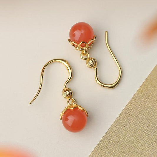 "Handmade Tibetan Buddhist Xiaoqingjing South Red Coral ear pendants in 925 silver, symbolizing purity and spiritual balance."