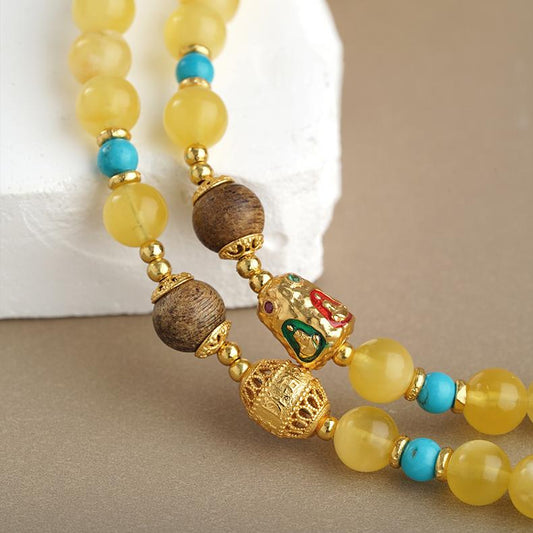 Amber and agarwood necklace featuring 925 silver Padmasambhava beads and Buddhist symbolic craftsmanship.