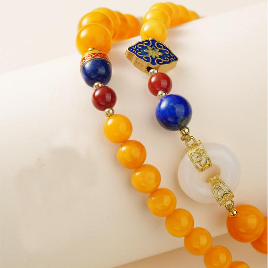 Tibetan amber and red agate necklace symbolizing blessings, vitality, and spiritual awakening.