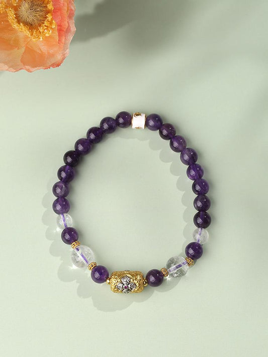 Adjustable Tibetan-Buddhist Amethyst and Clear Quartz bracelet crafted with mixed bead sizes and bronze Lu Lu Tong charm.