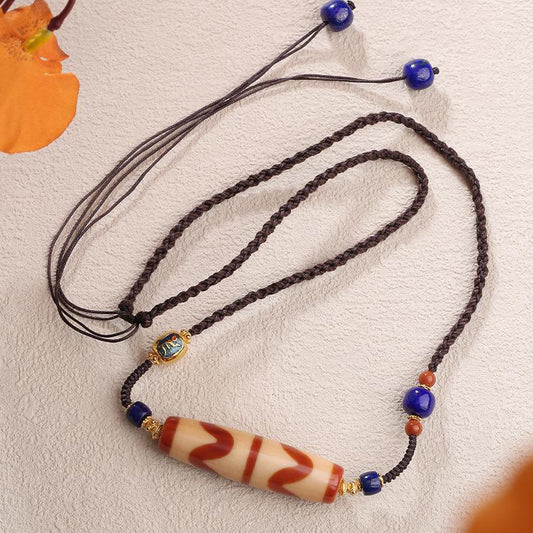 Artisan Tibetan Buddhist double agate and carnelian tooth bead pendant with adjustable cord.