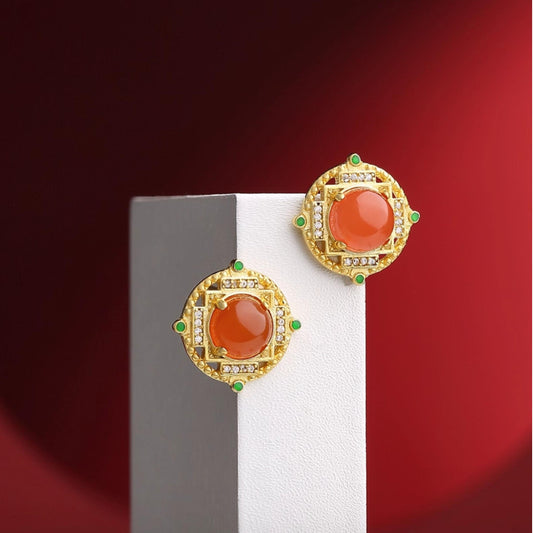"Tibetan Buddhist-inspired South Red Coral ear studs with 925 silver, representing happiness and the celebration of life."