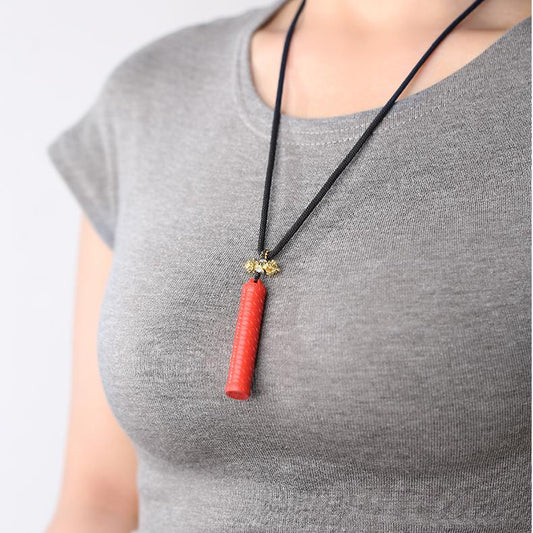 "The Tibetan Buddhist authority stick pendant necklace, made of cinnabar, incorporates traditional Tibetan thangka art, symbolizing wisdom and power."
