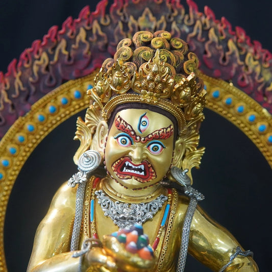 Traditional hand-painted Tibetan Buddhist wealth deity statue, a copper figure representing sacred Buddhist art.