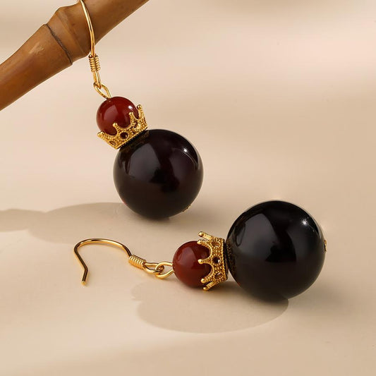 "Handmade Tibetan Buddhist blood amber and agate earrings with 925 silver crown, symbolizing spiritual strength and vitality."