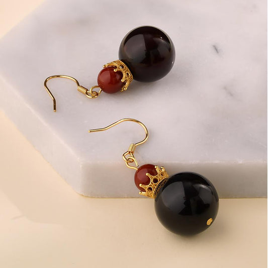"Tibetan Buddhist-inspired blood amber and agate earrings, handcrafted with 925 silver crown, representing purification and energy."