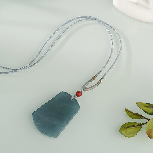 Handcrafted Tibetan Buddhist blue water jade peace pendant symbolizing serenity and clarity.