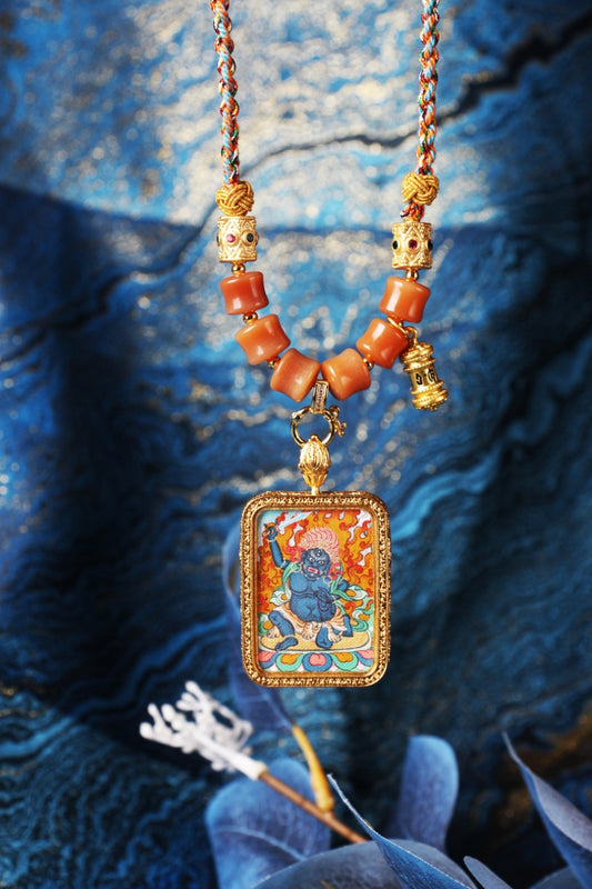 The Karma Kagyu Acala Thangka pendant displayed as a sacred amulet for discipline and obstacle removal, embodying the fierce wisdom of Tibetan Buddhist tradition.