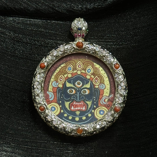 A 3x3cm hand-painted Rekong Red-Gold Acala Buddha Head Thangka pendant featuring the Immovable One, representing discipline and protection in Buddhist tradition.