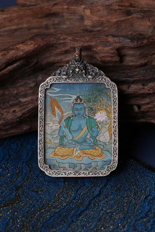 Tibetan thangka amulet featuring Akasagarbha Bodhisattva, revered for infinite compassion and generosity in Tibetan Buddhism.
