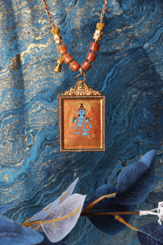 The Rebgong Akasagarbha Thangka pendant displayed as a sacred amulet for wealth and prosperity, embodying the space treasury wisdom of Tibetan Buddhist tradition.
