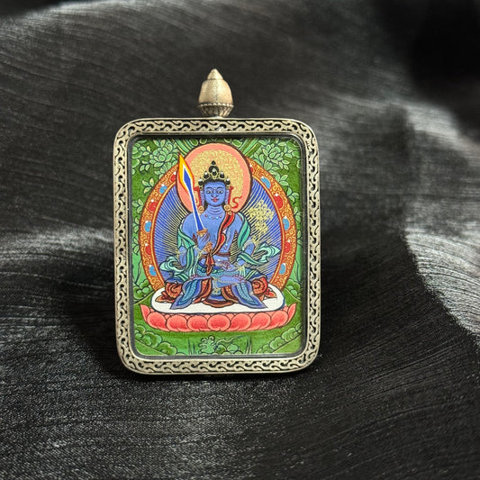 Detailed view of the presentation and casing for the Akasagarbha Cuiying Thangka pendant, symbolising protection and tradition in Buddhist practice.