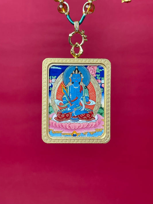 The Tibet Akasagarbha Thangka pendant with hand-woven cord displayed as a sacred amulet for wealth and noble help, embodying Buddhist tradition.