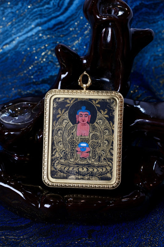 Amitabha thangka pendant representing the Pure Land Buddha, symbolizing peace, rebirth, and enlightenment.