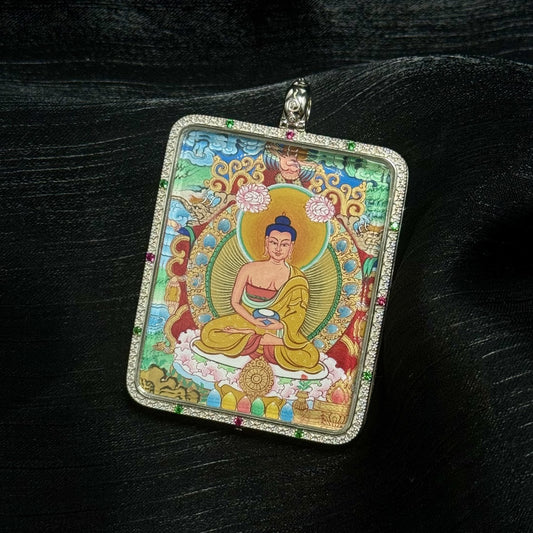 A 4x5cm hand-painted Menri-style Amitabha Buddha Thangka pendant featuring the Lord of the Western Pure Land, encased in double-sided 925 silver, symbolising liberation and peace in Tibetan Buddhist tradition.