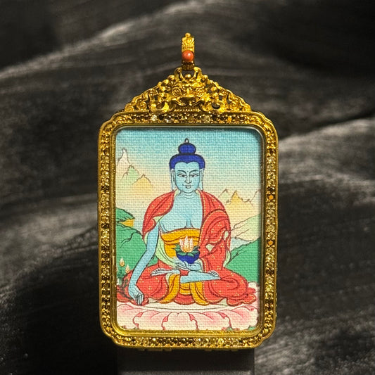 A 2.5x3.5cm hand-painted Tibet Bhaisajyaguru (Medicine Buddha) Thangka pendant featuring healing and longevity, representing peace and blessing in Buddhist tradition.