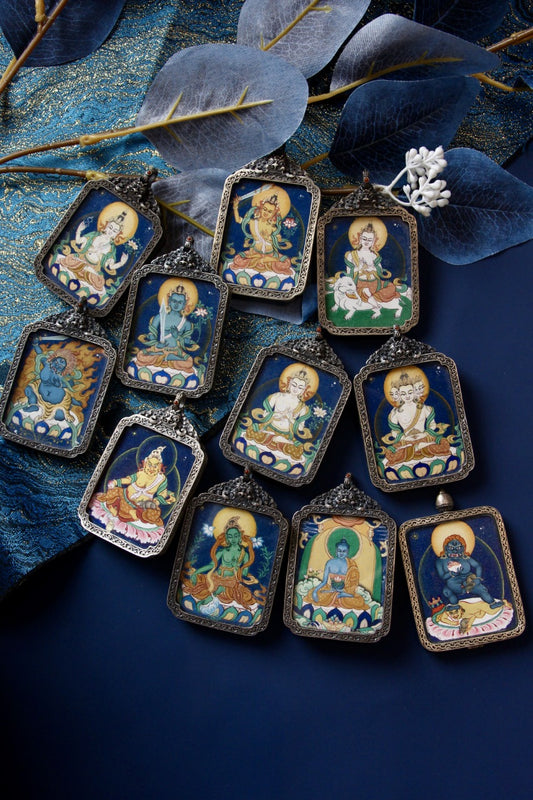 Black Dzambhala thangka pendant representing abundance, good fortune, and spiritual protection in Tibetan Buddhism.