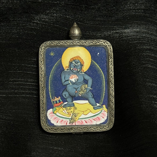 The Tibet Coarse Black Jambhala Thangka pendant displayed as a sacred amulet for swift wealth and protection, embodying Tibetan Buddhist tradition.