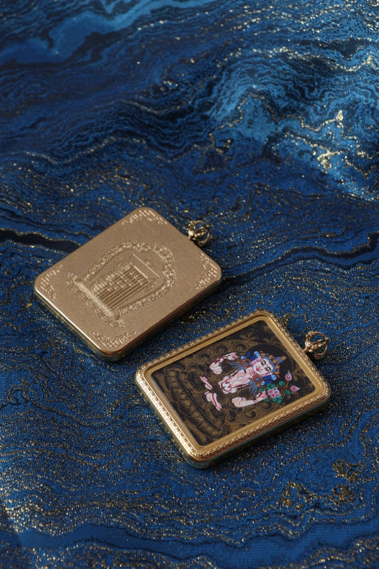 Four-Armed Avalokiteshvara thangka pendant depicting the Tibetan Buddhist deity of compassion, protection, and enlightened mercy.