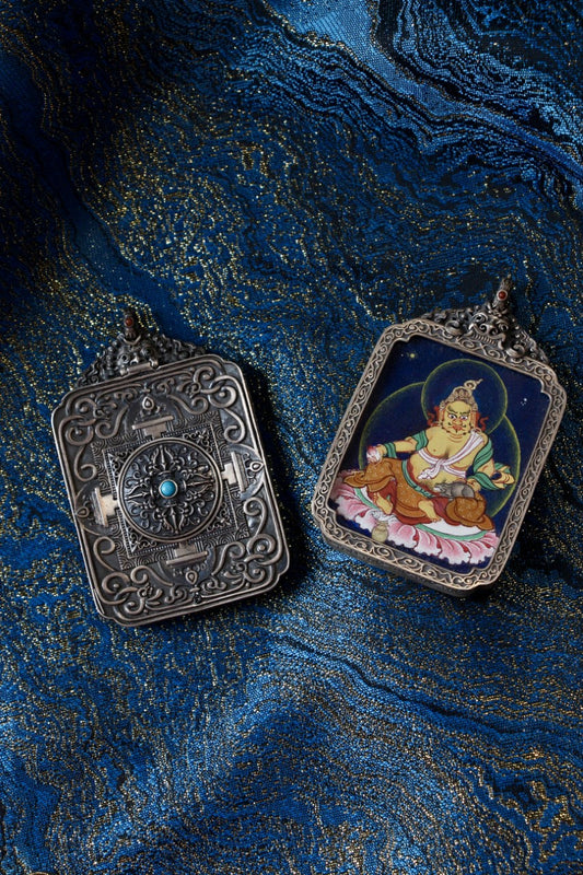 Yellow Jambhala thangka pendant depicting the Tibetan Buddhist wealth deity, symbolizing prosperity, abundance, and generosity.