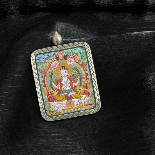 A 4x5cm hand-painted Menri-style Four-Armed Avalokiteshvara Thangka pendant featuring the embodiment of great compassion, encased in 925 silver with Dunhuang Nine-Colour Deer design, symbolising family peace and health in Tibetan Buddhist tradition.