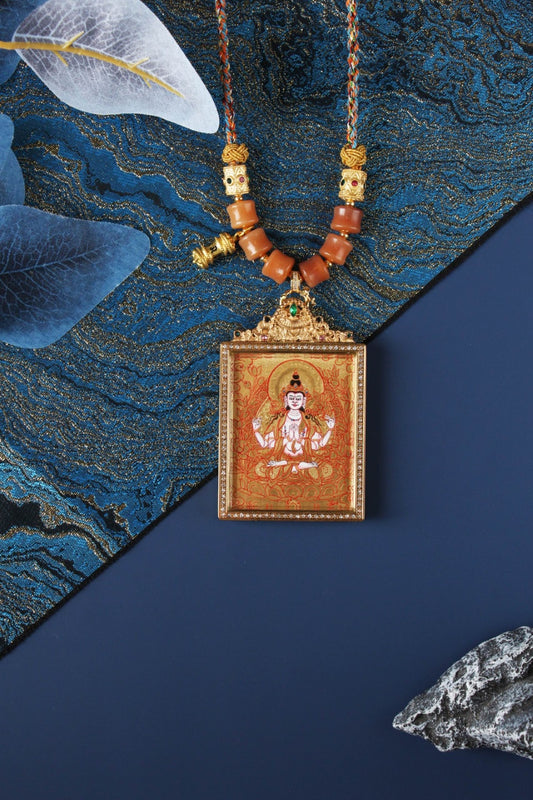 Detailed view of the titanium steel casing for the Four-Armed Avalokiteshvara Thangka pendant, symbolizing protection and elegance in Tibetan Buddhist tradition.