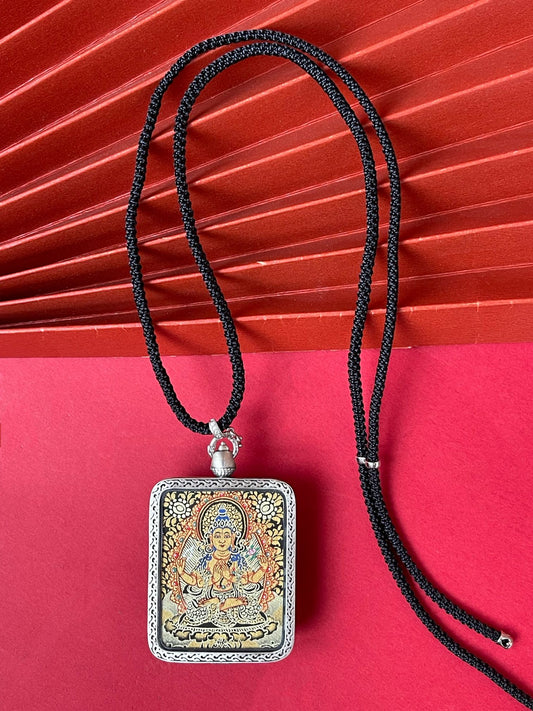 Hand-painted Rekong Black Gold Four-Armed Avalokiteshvara (四臂观音) Thangka pendant 3.5x4.5cm with deer relief silver casing featuring the Bodhisattva of Compassion, representing compassion and family harmony in Buddhist tradition.