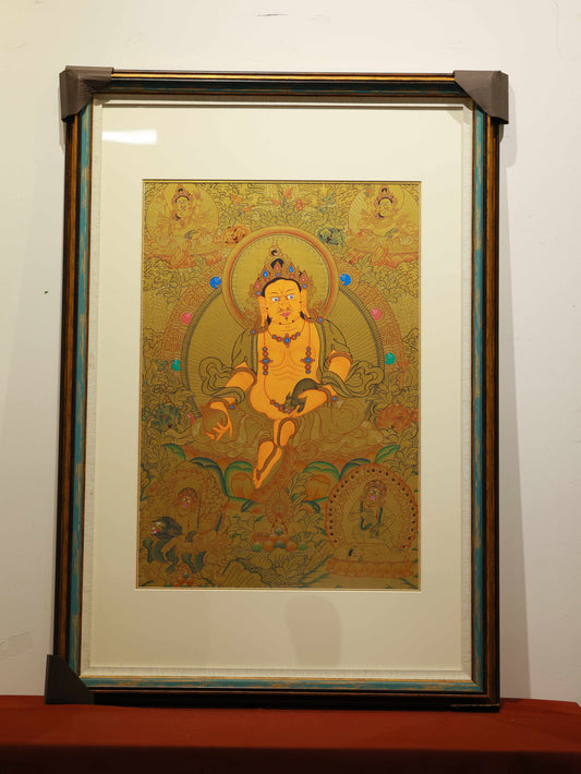 Golden Yellow Jambhala Thangka 02 – Tibetan Buddhist thangka depicting the Golden Yellow Jambhala seated on a lotus throne, representing abundance and spiritual blessings.