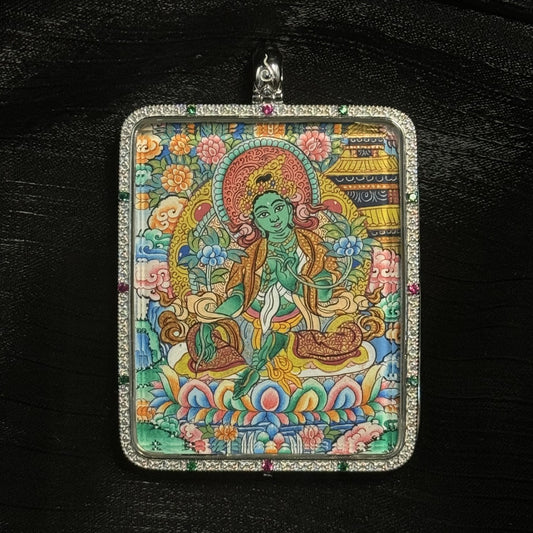 The Green Tara with Mandala Thangka pendant displayed as a sacred amulet for love, career and harmony, embodying Tibetan Buddhist tradition.