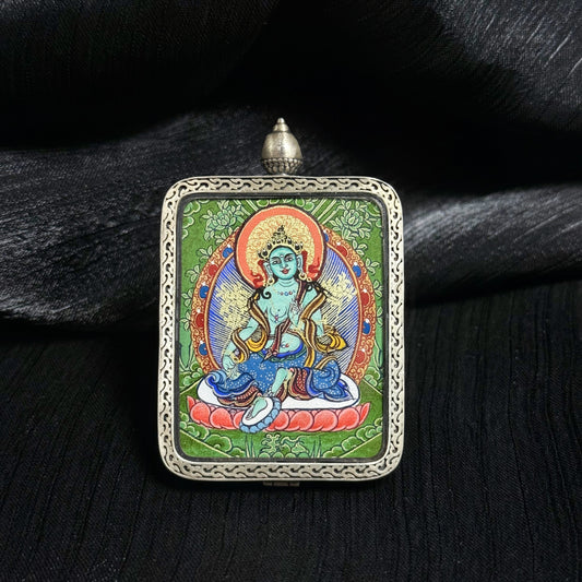 Close-up detail of the Rekong Cuiying Green Tara Thangka painting showing natural mineral pigments.