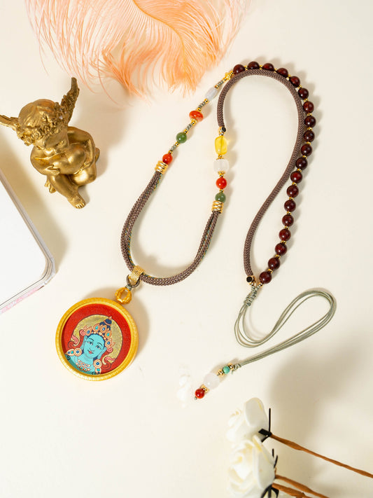 Hand-painted Rekong Red Gold Green Tara (绿度母) Thangka pendant 3.5cm with copper casing featuring the incarnation of Avalokiteshvara's tears, representing relieve suffering and all wishes fulfilled in Buddhist tradition.