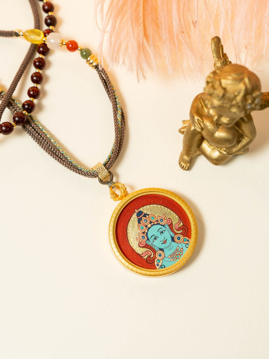 Detailed view of the refined copper casing for the Green Tara Thangka pendant, symbolising compassion and tradition in Buddhist practice.