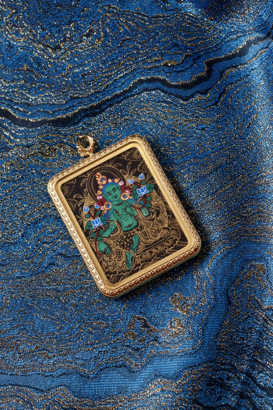Green Tara thangka pendant depicting the Tibetan Buddhist goddess of compassion, protection, and swift enlightened action.