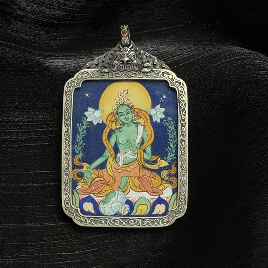 The Tibet Coarse Green Tara Thangka pendant displayed as a sacred amulet for compassion and wisdom, embodying Tibetan Buddhist tradition.