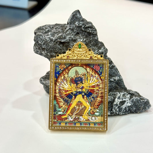 Hand-painted Rebgong Kalachakra Thangka pendant featuring the Wheel of Time deity, encased in titanium steel, representing compassion, wisdom, and liberation in Tibetan Buddhist tradition.