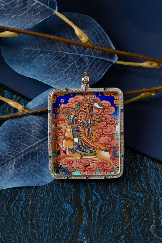 Tibetan Buddhist thangka pendant depicting King Gesar as a sacred warrior protector, symbolizing courage, protection, and spiritual power.