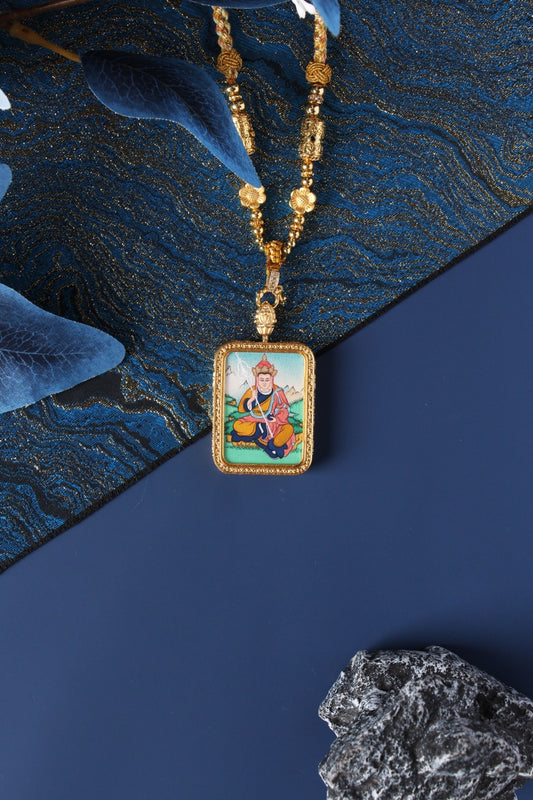 Close-up detail of the Tibetan Buddhist Ksitigarbha Thangka painting showing intricate natural mineral pigment work and serene expression, showcasing the masterful artistry of Tibetan lineage painters.