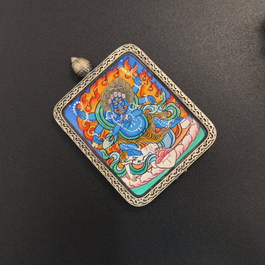 A 4x5cm hand-painted Rekong Mahakala (大黑天) Thangka pendant with 925 silver casing featuring the great protector, representing protection and fortune in Buddhist tradition.