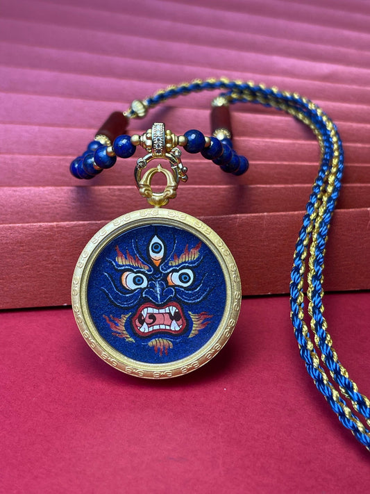 Hand-painted Tibet Mahakala (大黑天) Thangka pendant 3cm with copper casing and lapis agate necklace featuring the wrathful protector and wealth deity, representing abundance and family harmony in Buddhist tradition.