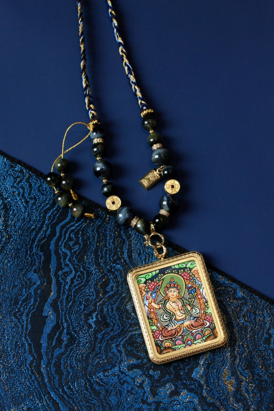 Manjushri thangka pendant representing supreme wisdom and intellectual awakening in Tibetan Buddhist culture.