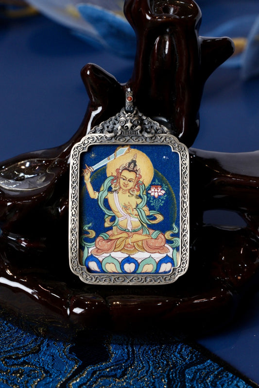 Manjushri thangka pendant representing supreme wisdom and clarity in Tibetan Buddhist culture.